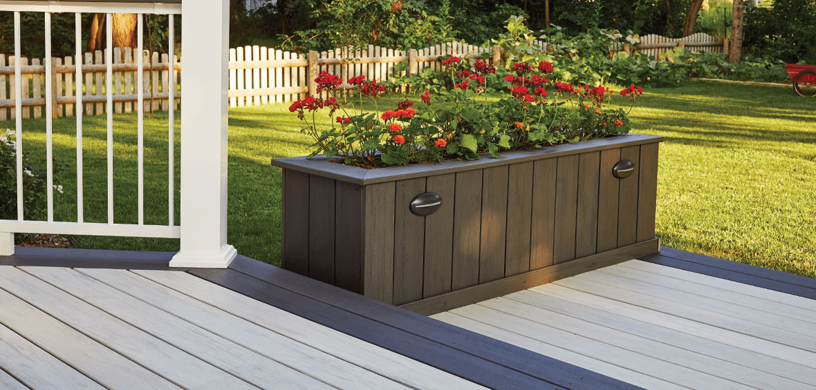 In a cottage garden, unique planters designed from decking materials, enhancing the garden with a rustic, creative touch
