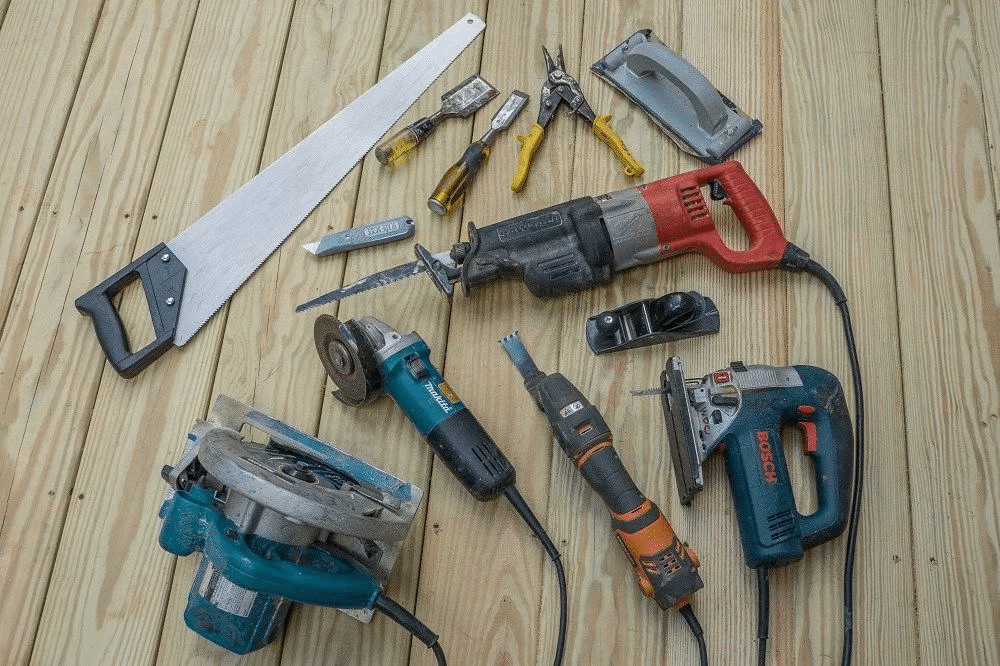 Essential tools for installing composite decking, including screws, drill, and hidden fasteners